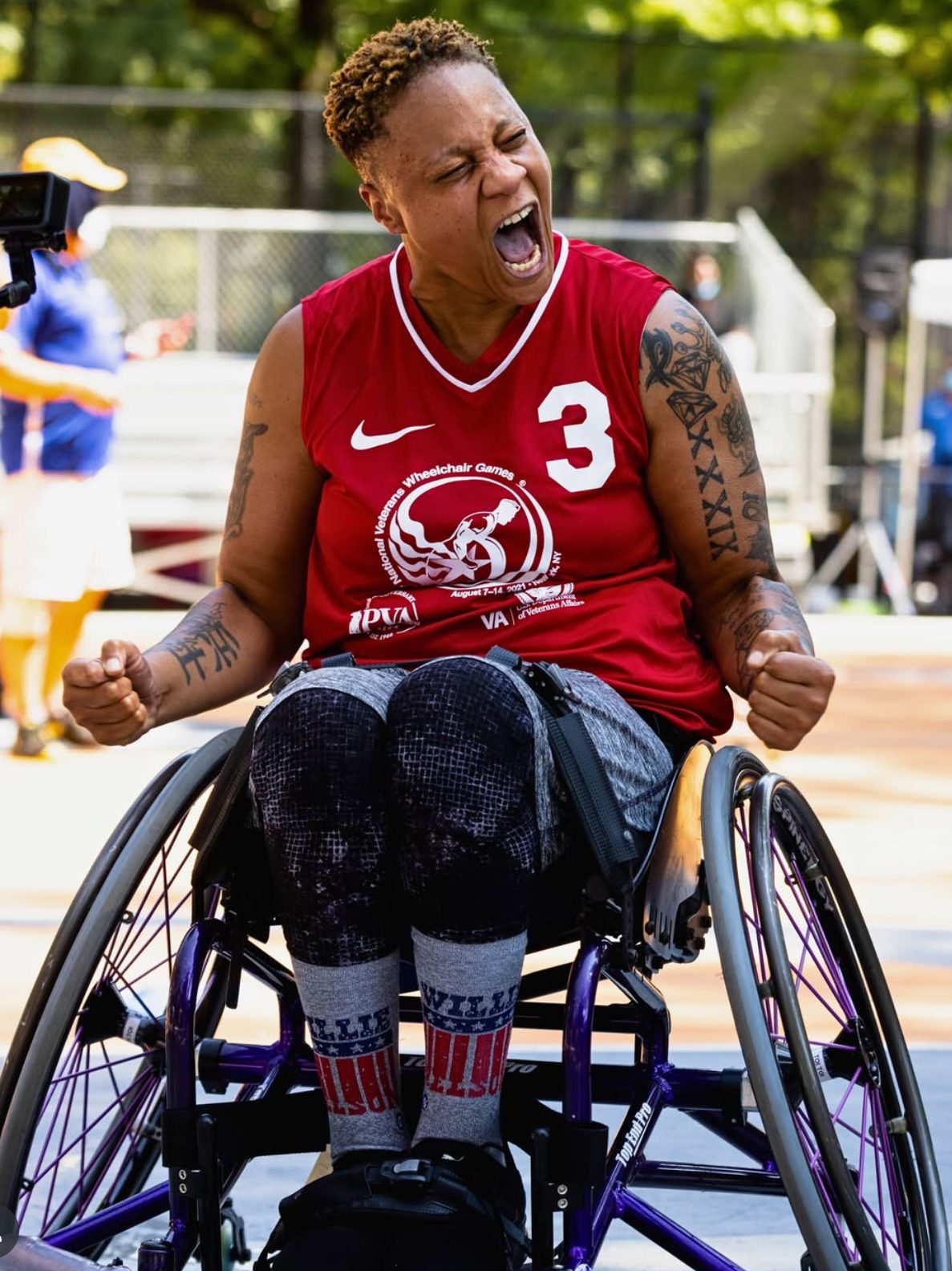 woman athlete in wheelchair screaming happily